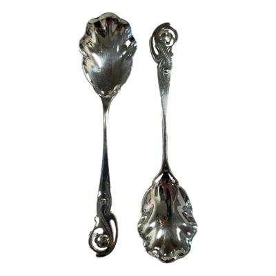 Matching pair of antique sterling silver jam spoons. Wonderful design spoons typical of the Art Nouveau era. Fully hallmarked for Sheffield assay and made by William Batt & Sons c1904. Each spoon measures 152mm long and bowl area measuring approximately 50mm by 36mm. Main photo of both spoons laid tip to tail vertically