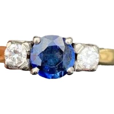 Vintage 18 karat gold trilogy ring set with a round cut sapphire of approximately 0.25 carat to centre with a 5 point sparkly diamond to either side. Ring size N / 6.75. Main photo showing ring front.