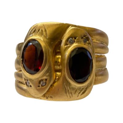 Art Deco double snake ring in 9 karat gold c1921. Each snake has an oval cut garnet to the top of their heads with small round cut diamonds for eyes. There is unusually a full hallmark on each of the 3 joined inner bands. Ring size V / 10.5 Main photo of ring seen from an eye level from the front.