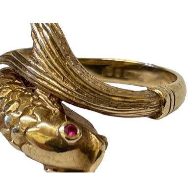 Vintage 9 karat gold ring in the form of a fish swimming in a turn with head and tail forming the ring front. Lovely detailing of fins and scales makes this ring extra special. 2 small rubies make up the eyes to complete this wonderful goldfish! Full hallmark to inside band for London assay c1958. Ring size J / 5. Close up photo of ring front showing the scales detail on the fins and body.