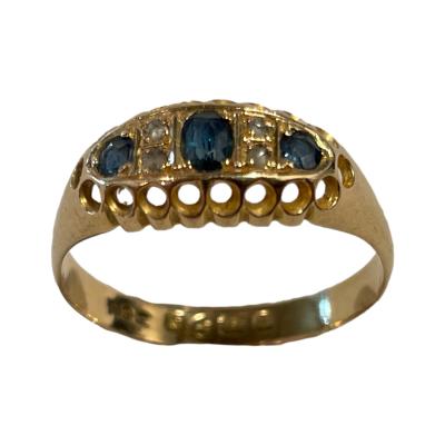 Antique 18 karat gold ring set with 3 sapphires and diamond chips. Full hallmark to inside band for Chester assay c1913. Ring size S.5 / 9.25 Main photo of ring seen with ring front raised and to the centre foreground.