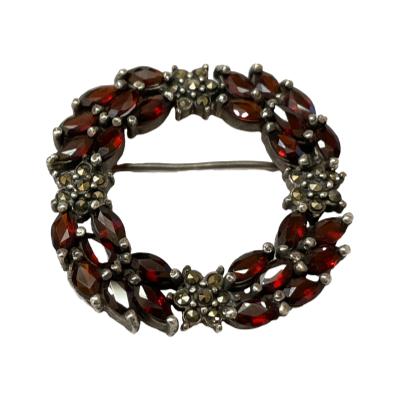 Vintage style sterling silver brooch with garnets and marcasite. Hallmarked 925 for sterling silver to the back. Main photo of brooch shown from the front straight on.