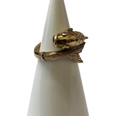Vintage 9 karat gold ring in the form of a fish swimming in a turn with head and tail forming the ring front. Lovely detailing of fins and scales makes this ring extra special. 2 small rubies make up the eyes to complete this wonderful goldfish! Full hallmark to inside band for London assay c1958. Ring size J / 5. Photo of ring on a cone shaped display stand focusing on the fish head showing the ruby eyes.