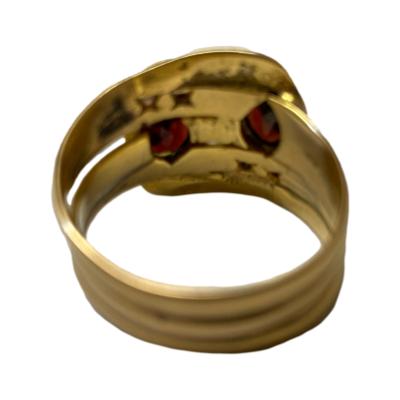 Art Deco double snake ring in 9 karat gold c1921. Each snake has an oval cut garnet to the top of their heads with small round cut diamonds for eyes. There is unusually a full hallmark on each of the 3 joined inner bands. Ring size V / 10.5 Photo of back of ring looking at the back of the snake heads at front. Photo is a little blurry.