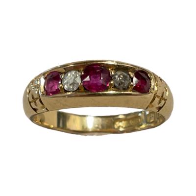 An antique Victorian 18 karat gold ring set with 3 round cut rubies which are separated by 2 diamonds. Fully hallmarked to inside band for Birmingham assay c1876. Ring size O / 7. Main photo of ring seen with precious stones of rubies and diamonds facing forward.
