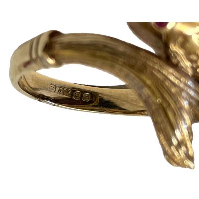 Vintage 9 karat gold ring in the form of a fish swimming in a turn with head and tail forming the ring front. Lovely detailing of fins and scales makes this ring extra special. 2 small rubies make up the eyes to complete this wonderful goldfish! Full hallmark to inside band for London assay c1958. Ring size J / 5. Close up photo of hallmark on inside band.