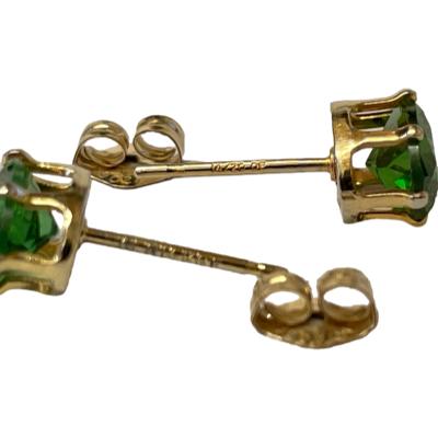14 karat gold stud earrings set with half a carat of oval cut chrome diopside to each. Hallmark to the earring posts. Each stone measures approximately 6mm x 4.5mm. Photo of earrings laid top to tail with butterflies removed and showing the hallmarks to the posts and butterflies.