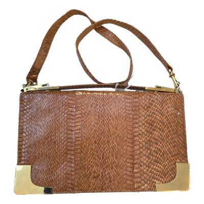 Real snake skin shoulder bag in a light tan colour. Can detach the shoulder strap (some stretching) and just use the top handle. Features gold tone trims.  Main photo of bag shown upright with strap handle folded at the top and shorter handle visible.
