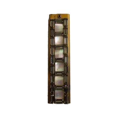 The Mother of Pearl folding comb is set in gilt metal and has a label for Weisner. The comb opens out to reveal a brown plastic comb that slots into the housing. Main photo of comb in shut position showing the mother-of-pearl decoration.