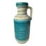 Mid century Austrian vase with a single handle. Large vase in turquoise blue and off white with thin green stripe. Measures 170mm in diameter at base, 195mm in diameter at widest, 115mm in diameter at mouth, 205mm wide to handle edge. COLLECT FROM STORE ONLY. Main photo of vase seen from an eye level angle with handle to the right of photo.