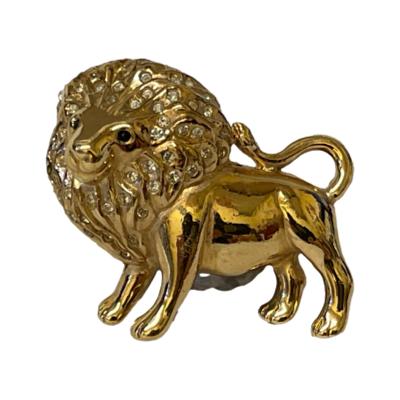 Vintage gilt metal lion brooch by Ciro. Rare brooch by iconic costume jewellery makers Ciro of a standing male lion with diamantes in his mane and blue eyes. Signed Ciro to the back. In excellent condition with clasp in good working order. Main photo of brooch showing full side view with head to left and tail to right of photo.