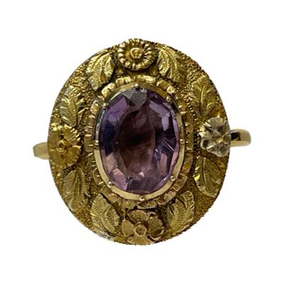 Antique gold and amethyst ring from the Georgian era. Tested 18 karat dome backed gold ring with an old cut oval amethyst set within a generous gold frame of a floral design. Ring face measures 20mm by 17mm. Size T / 9.5. Main photo of ring facing straight forward.