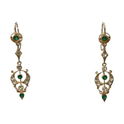 Edwardian style earrings in gold with paste stones. Pretty earrings evocative of Edwardian Lavaliere pendants in yellow gold with green and white paste stones. Secure clasp with hook closures. Drop length 55mm. Main photo of both earrings shown dangling from an invisible display stand and seen front on.