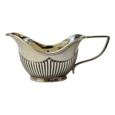 Antique creamer in sterling silver. Small creamer in a very classical Art Nouveau design. Full hallmark to the side for Birmingham assay and made by A & J Zimmerman Ltd c1902. Main photo of jug seen from an eye level side angle with spout to the left, handle to the right.