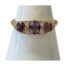 Victorian 18 karat gold trilogy ring. Pretty antique trilogy ring set with 3 oval cut amethysts which are separated with 2 round cut diamonds. The shoulders are plain in contrast to the very fancy gallery. Ring size S / 9. Main photo of ring displayed on a cone shaped stand and seen with the front facing forward.