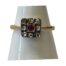 18 karat gold and platinum ring. Art Deco ring in 18 karat gold set with 8 small old mine rose cut diamonds and a 3 point ruby on a square platinum mount. Ring face measures 8mm square and weighs 2.1gms. Ring size N / 6.75. Main photo of ring on a cone shaped display stand with ring front facing forward.