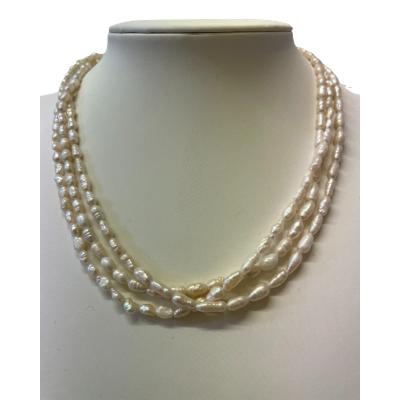 The three rows of freshwater pearls are a beautiful example of quality jewellery from a bygone era. The pearls are of differing sizes and shapes as would be expected. The string is a little loose and the necklace could benefit from restringing. Main photo of necklace displayed on a stand and looking directly from the front.