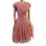 1950s Peachy pink dress with white flock floral. Slightly drop waist style with belt and a cross over front with diamanté. Full skirt with net petticoat attached for stiffness, great for dancing. Main photo showing the whole dress from the front and displayed on a mannequin