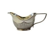 Antique creamer in sterling silver. Small creamer in a very classical Art Nouveau design. Full hallmark to the side for Birmingham assay and made by A & J Zimmerman Ltd c1902. Main photo of jug seen from an eye level side angle with spout to the left, handle to the right.