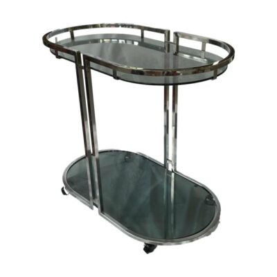 Mid century retro chrome and smoked glass hostess trolley. This very stylish and chic retro trolley will add sophistication to any room or event. Very practical and eye catching addition to any interior. COLLECT FROM STORE ONLY. Main photo of trolley shown at a diagonal angle with one end facing bottom right and other end in top left. Looking down from a slightly higher angle to show the smoky glass at the top and bottom level of the trolley.