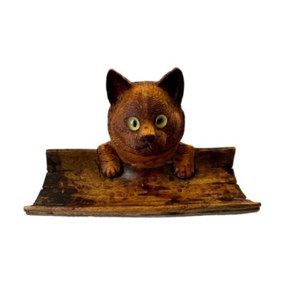 Antique ( circa 1900 -1920 ) Black Forest carved wood Cat inkwell and pen tray with glass eyes. It still has its original internal glass bottle but internally there is some black ink staining to wood. Main photo of the whole piece with cat facing directly at camera.