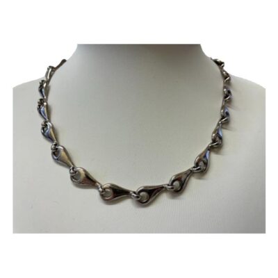 Modern chain in sterling silver. A substantial necklace with unusual links which look like sunflower seeds. Hallmarked 925 for sterling silver to the clasp and first link. Main photo of necklace displayed on a stand and shown forward facing.
