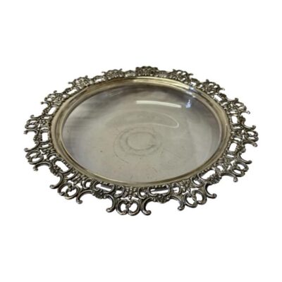 Victorian glass bowl with a sterling silver rim. Antique shallow bowl with an intricate sterling silver rim. Full hallmark to the side for London assay and made by Hutton's c1894. Measures 196mm in diameter across the top and approximately 140mm at base. Main photo of bowl seen from a raised height looking into centre of bowl. The grey beige colour to centre of bowl is the paper photo was taken on, the glass is clear glass.