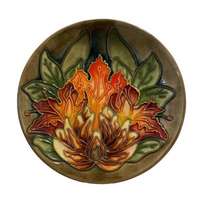 Moorcroft plate in flame of the forest pattern. Stunning dish in vibrant shades of green and orange. Designed by Philip Gibson c1997. Comes in box. Main photo of dish seen in full from the front showing the vibrant orange, brown and green colours.