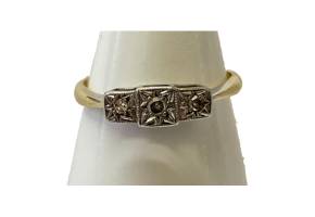 Art Deco gold and platinum ring. Art Deco ring with 3 small round cut diamonds in an unusual star patterned platinum setting finished with an 18 karat gold band. Ring size M / 6. Main photo of ring displayed on a cone shaped stand and seen with front forward facing.